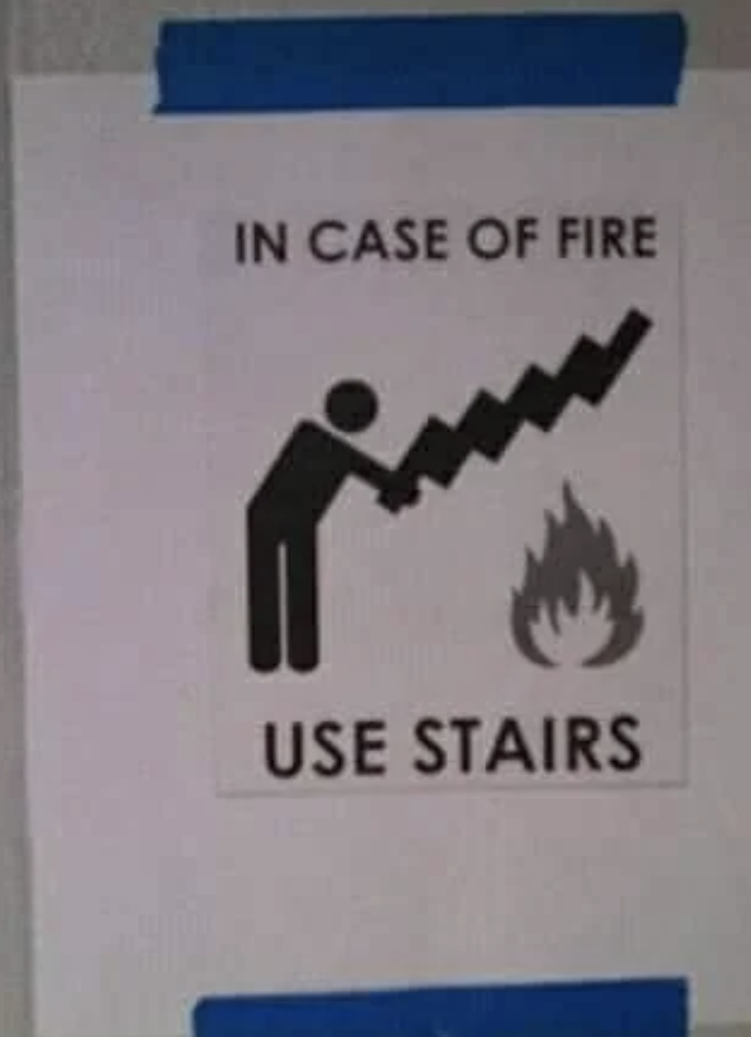 &quot;In case of fire use stairs&quot; with icon of person appearing to hold a stairway to attack a flame