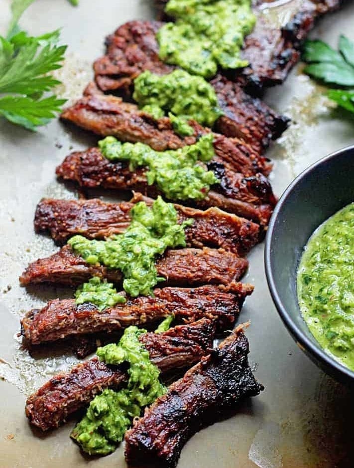 Sliced steak with green herb sauce