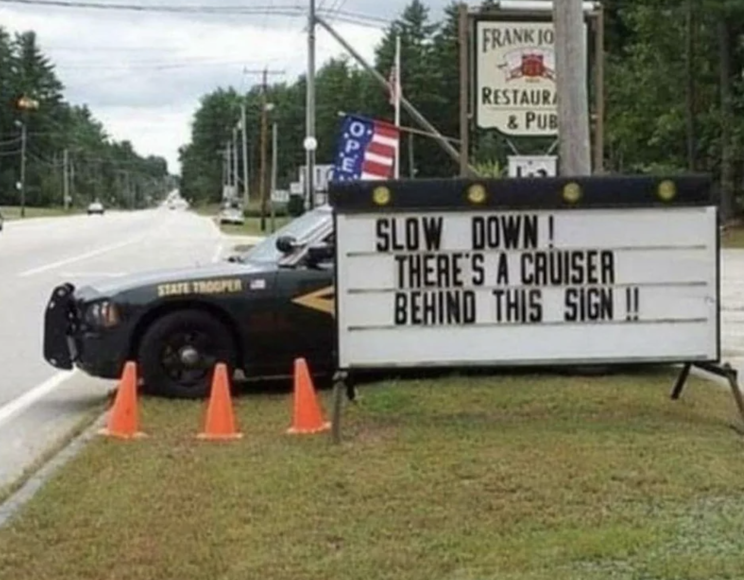 Road sign: Slow down! There&#x27;s a cruiser behind this sign!!