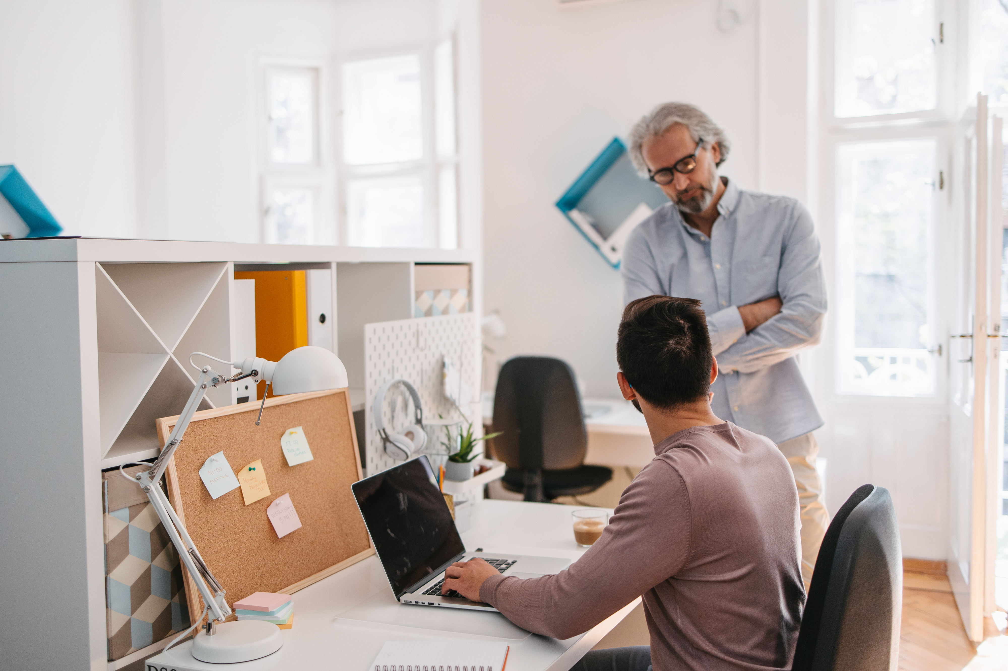 older manager speaking to his younger male worker