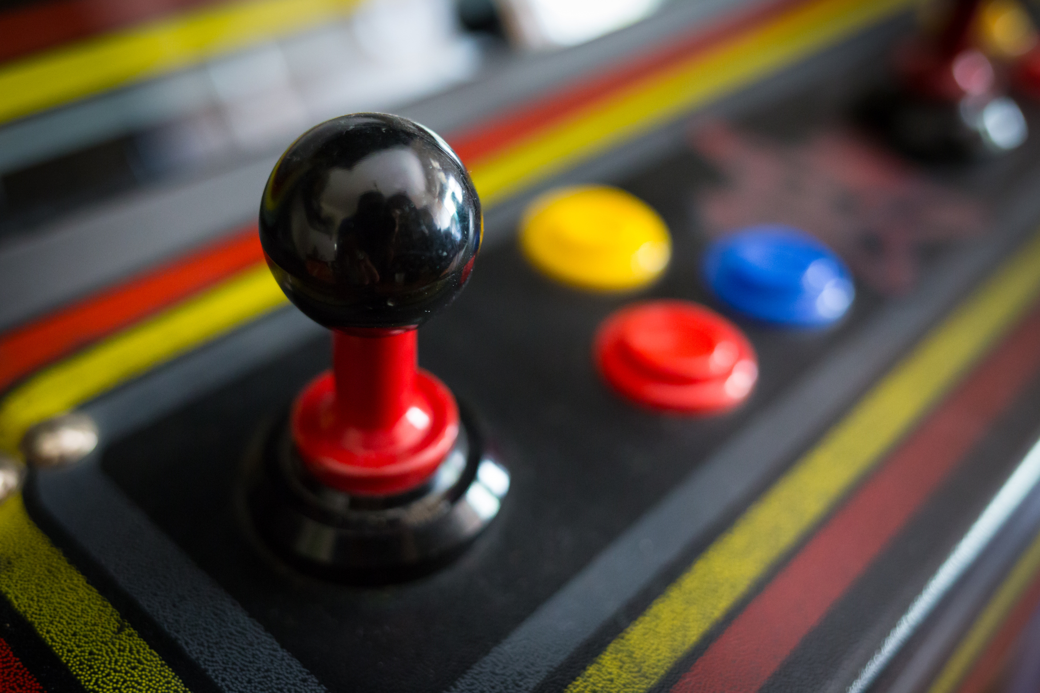 closeup of a joystick on an arcade game