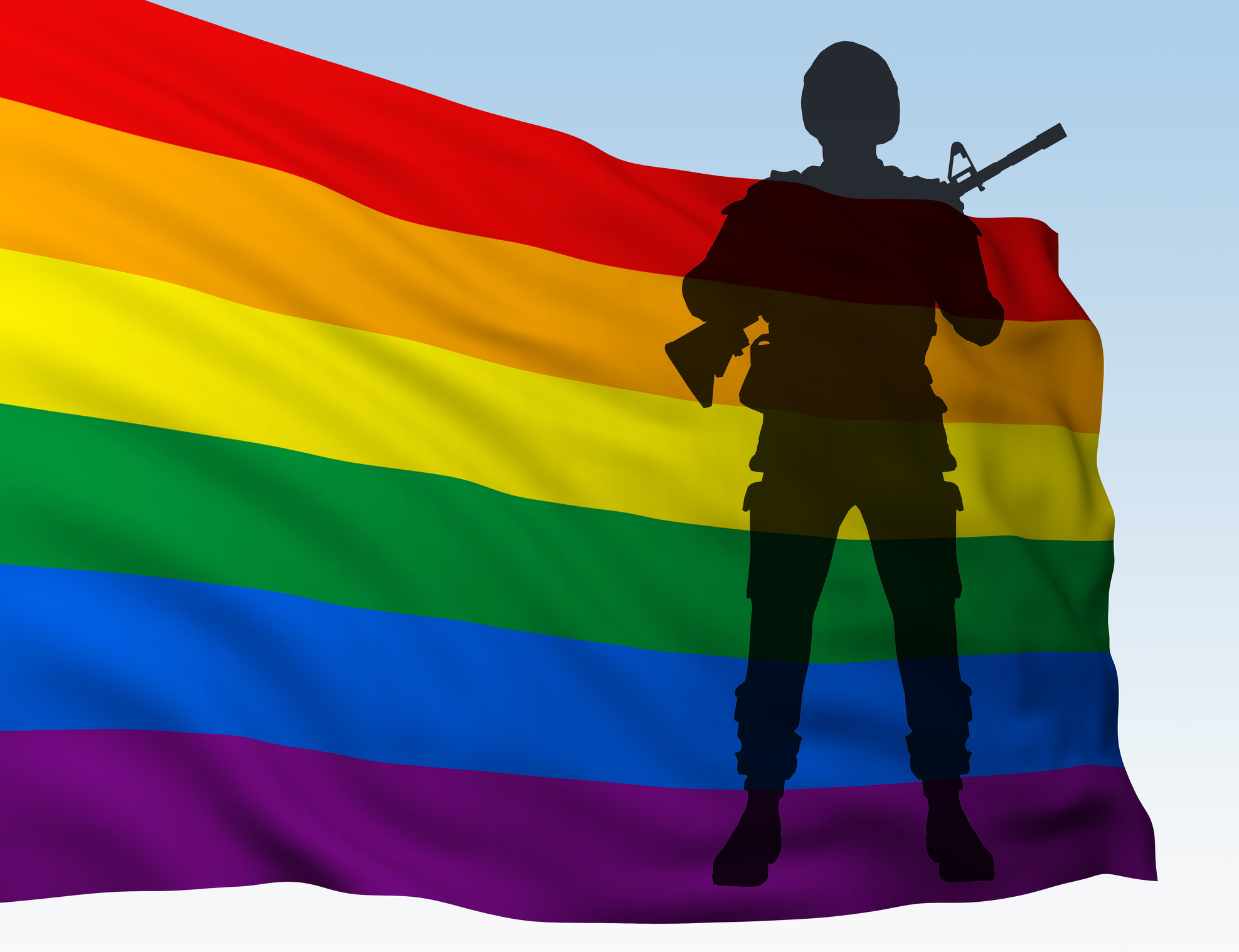 a soldier in front of a gay pride flag