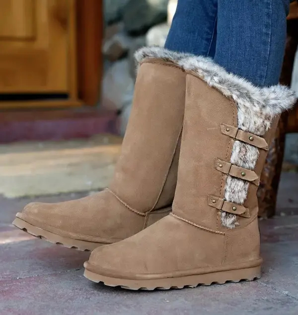 A pair of brown boots with furry interior.