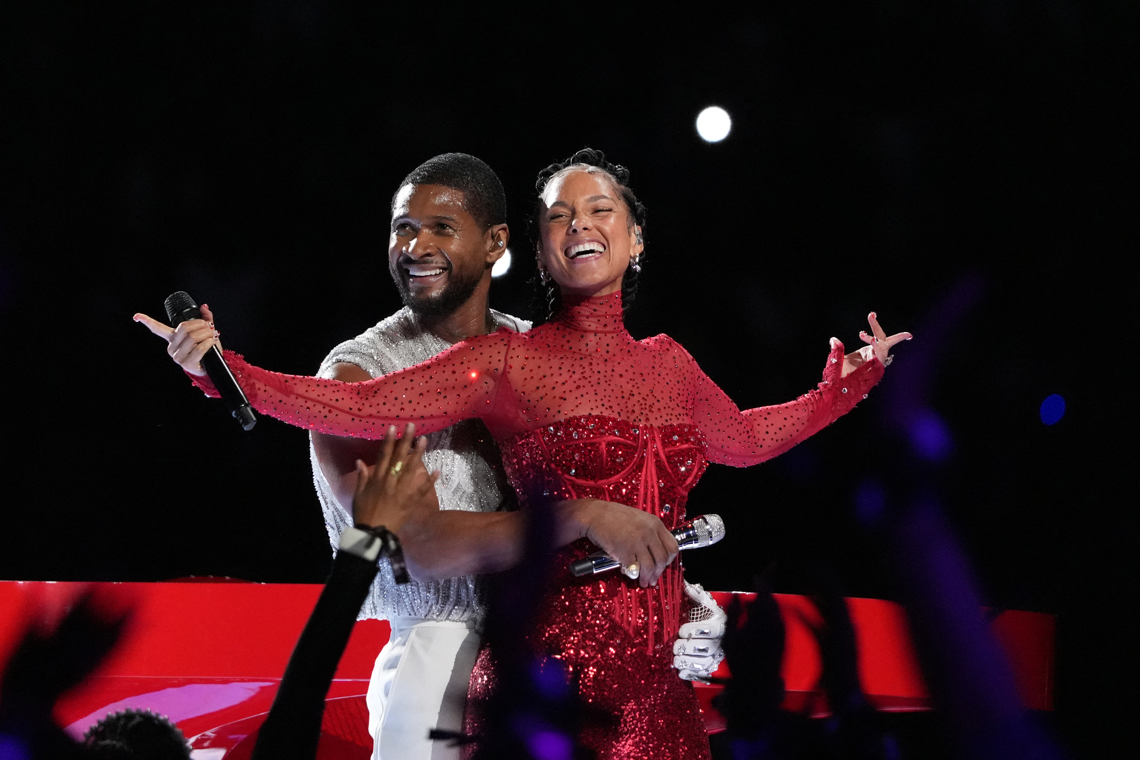 Usher and Alicia embracing and smiling