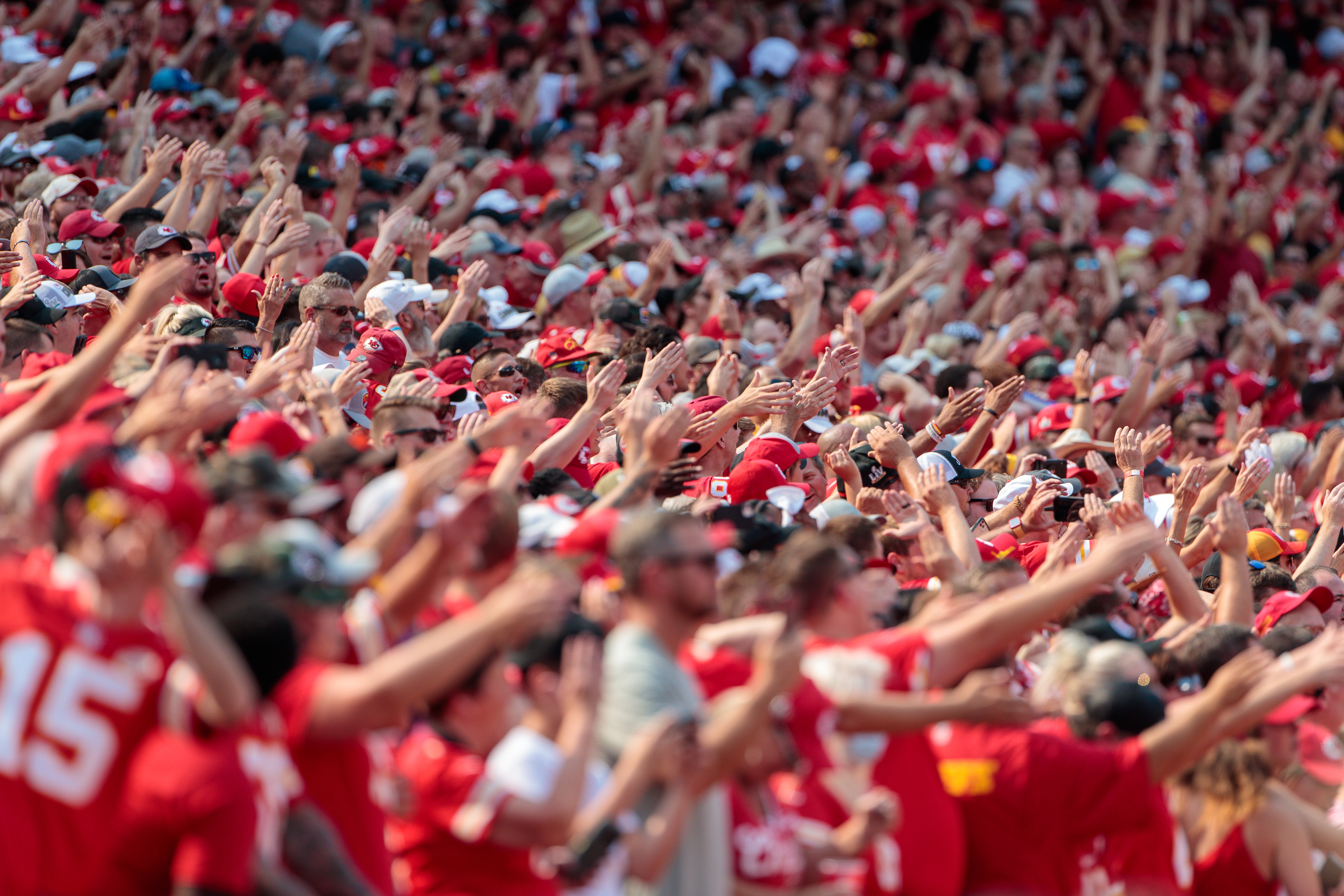 Chiefs fans with their arms raised