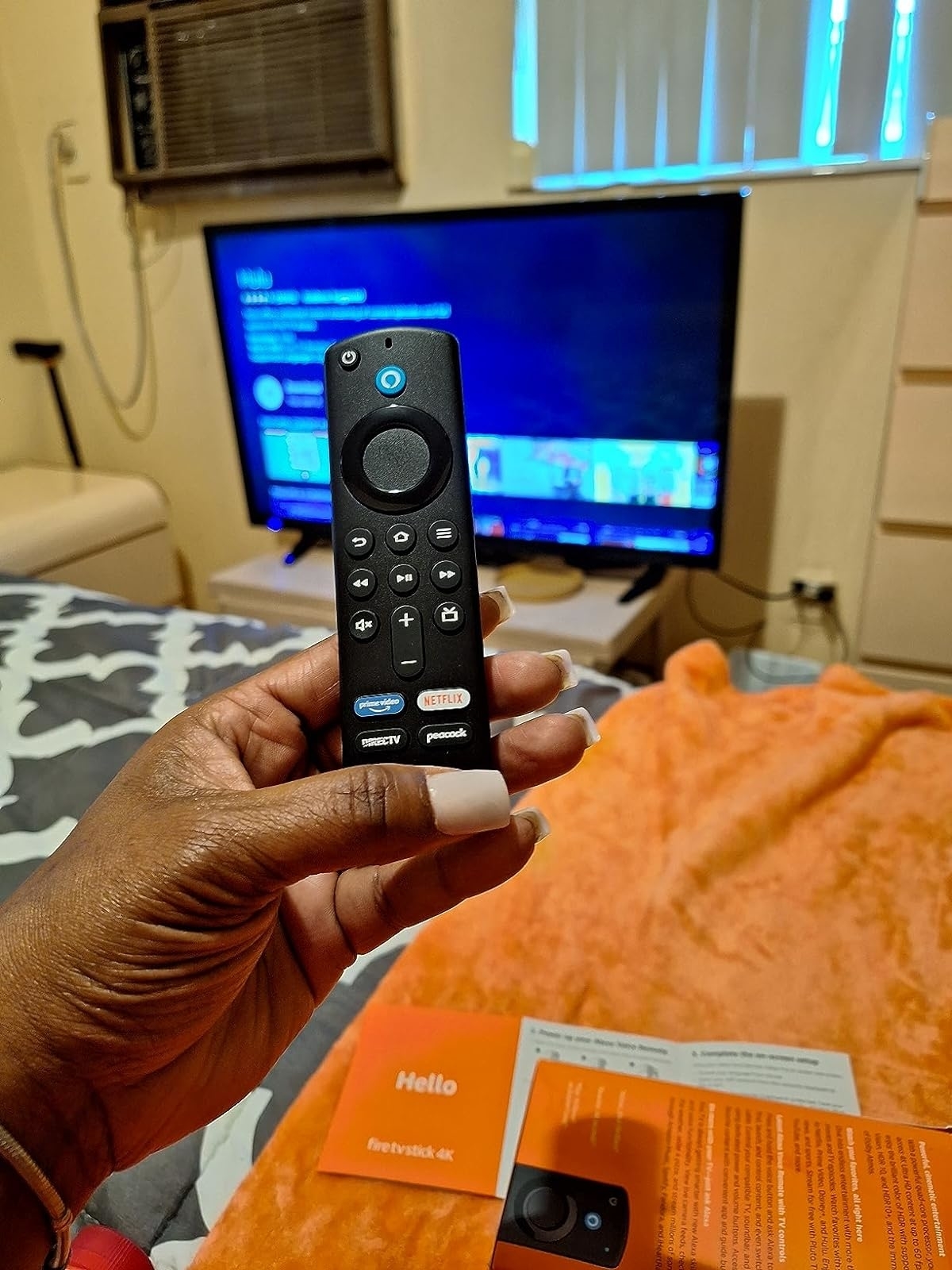 reviewer holding the black remote