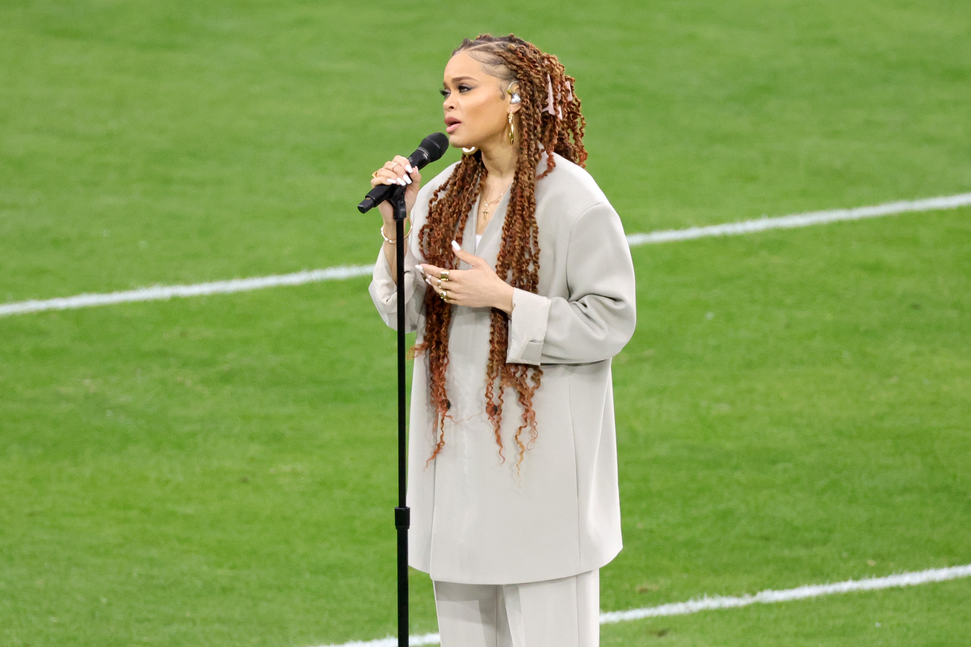 Andra Day singing on the field