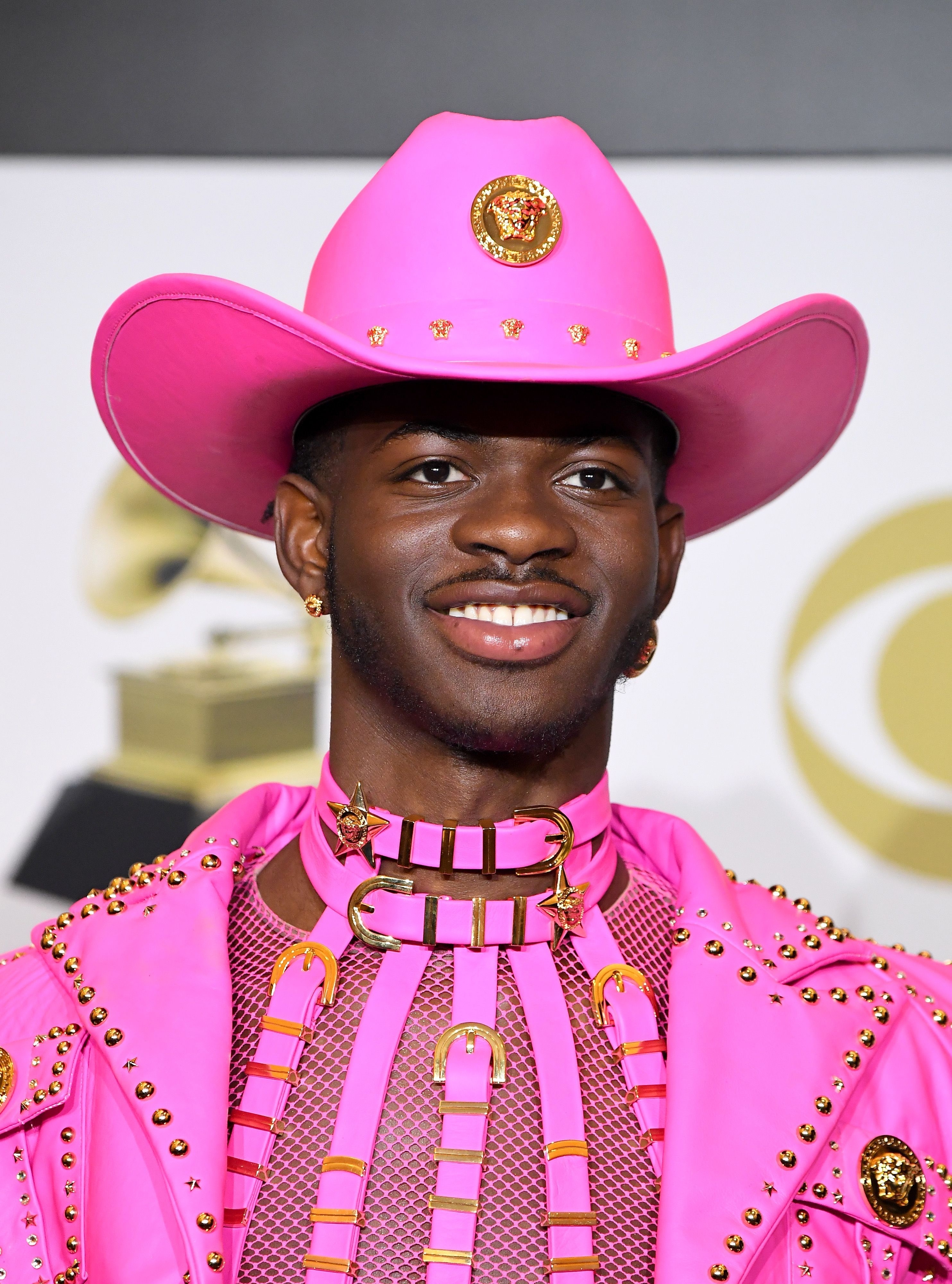 Close-up of Lil Nas in a pink Western-style hat and outfit