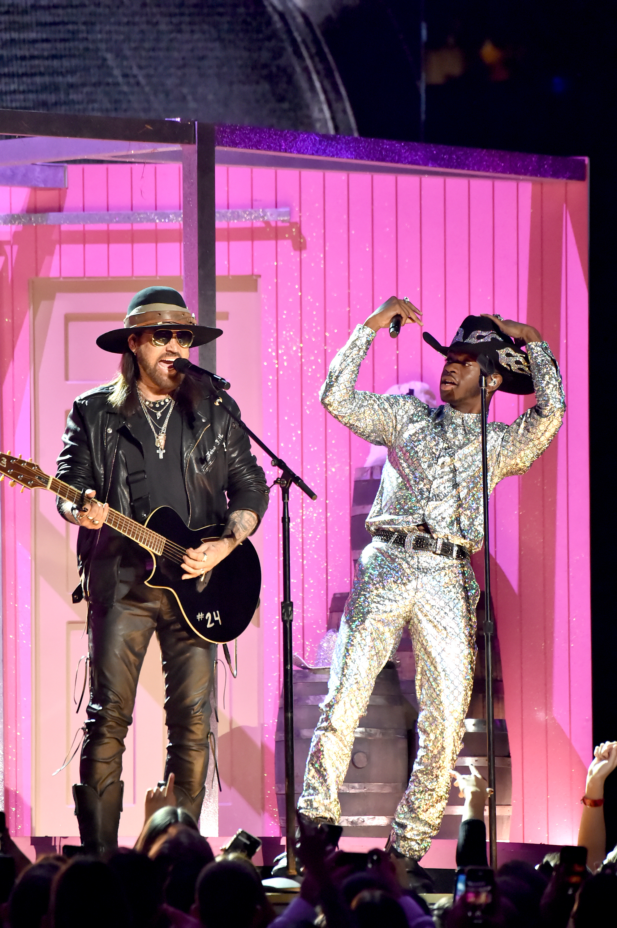 Close-up of Lil Nas performing in a Western-style hat and outfit