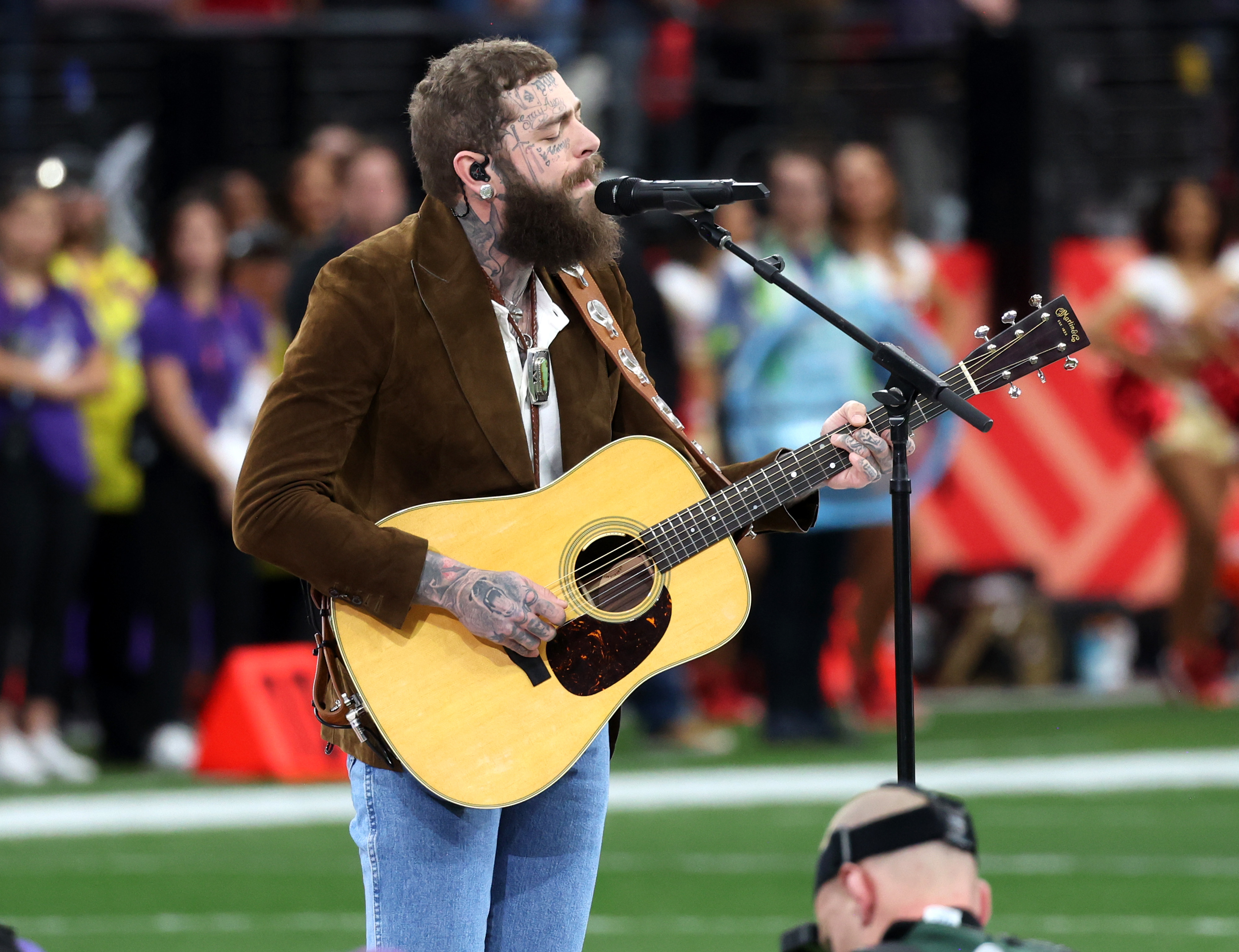 Post Malone singing on the field