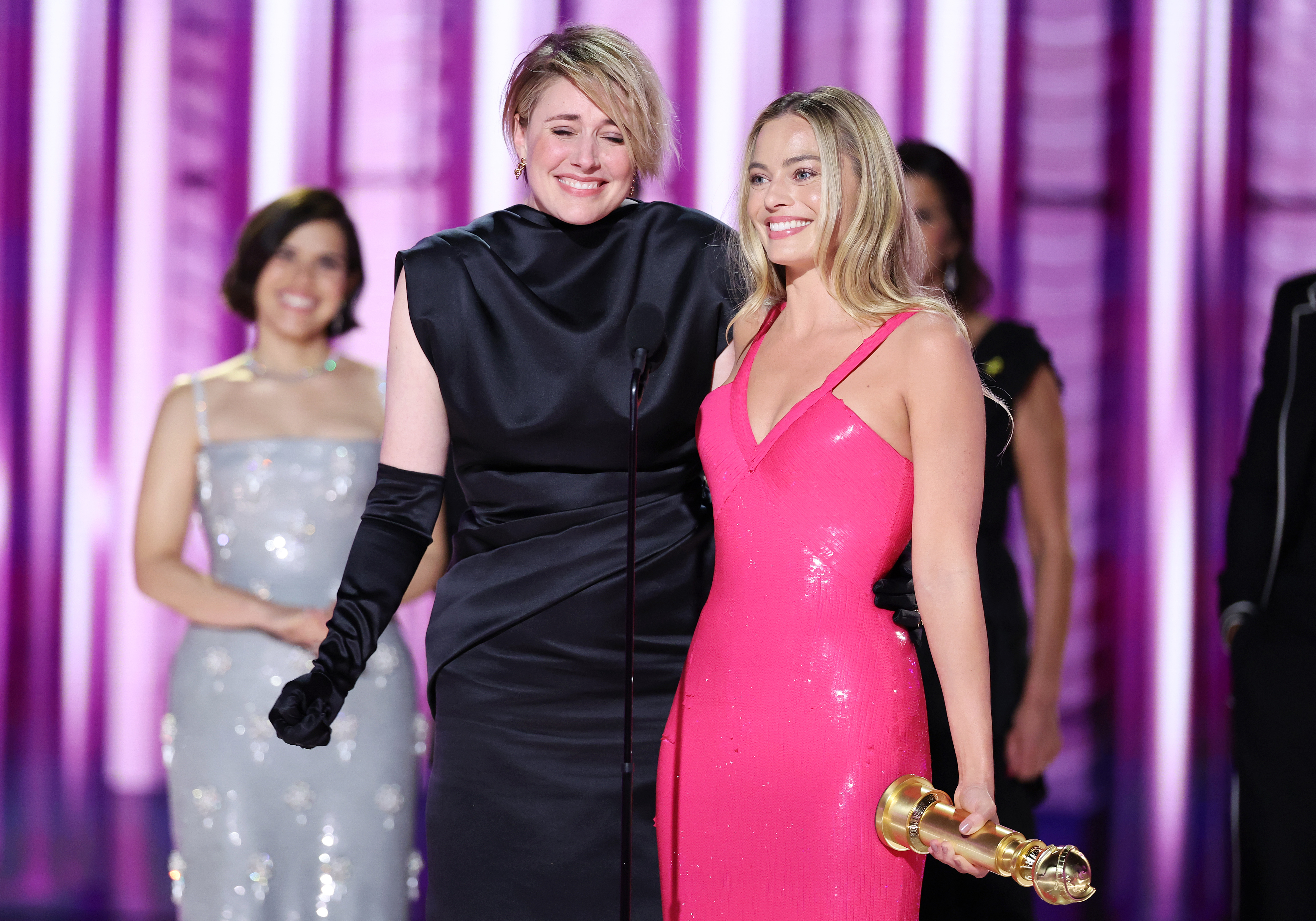Greta Gerwig and Margot Robbie accepting their Golden Globe for &quot;Barbie&quot;