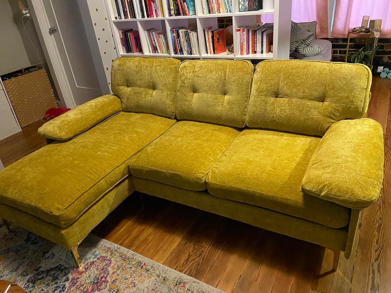 Reviewer&#x27;s yellow sectional in a living room