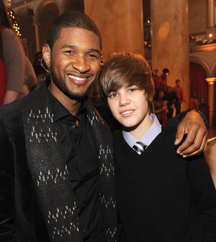 Usher and a teen Justin smile for a photo