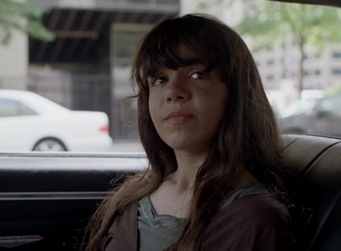 her character sitting in a car