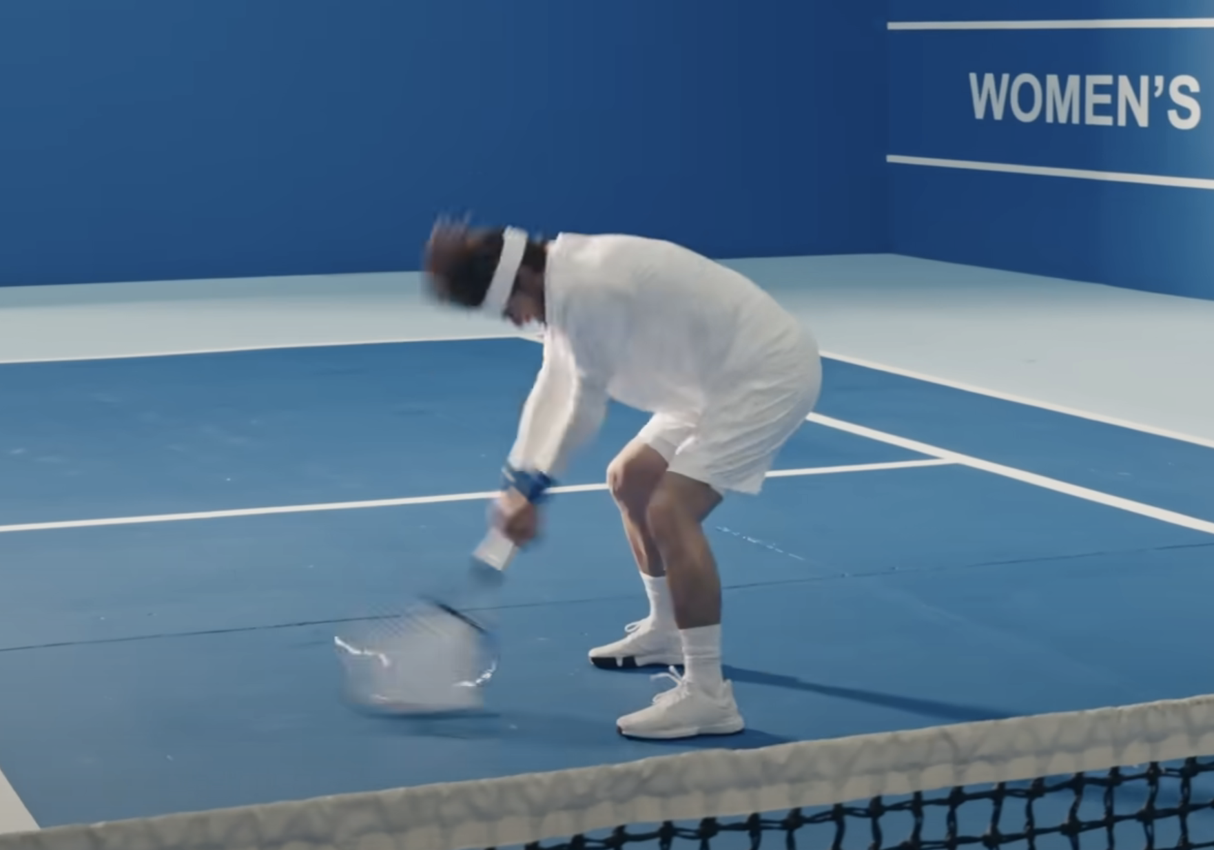 A man trashing a tennis racket