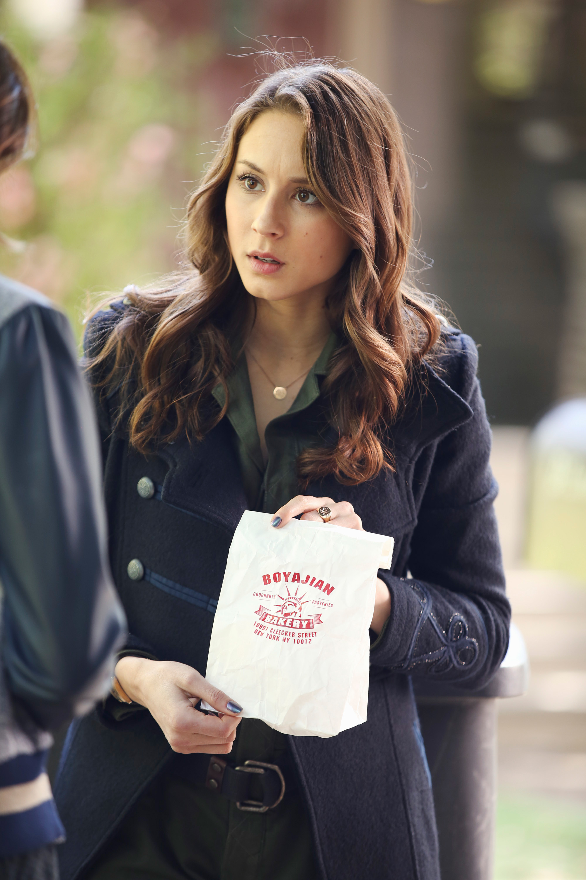 her character holding up a bakery bag