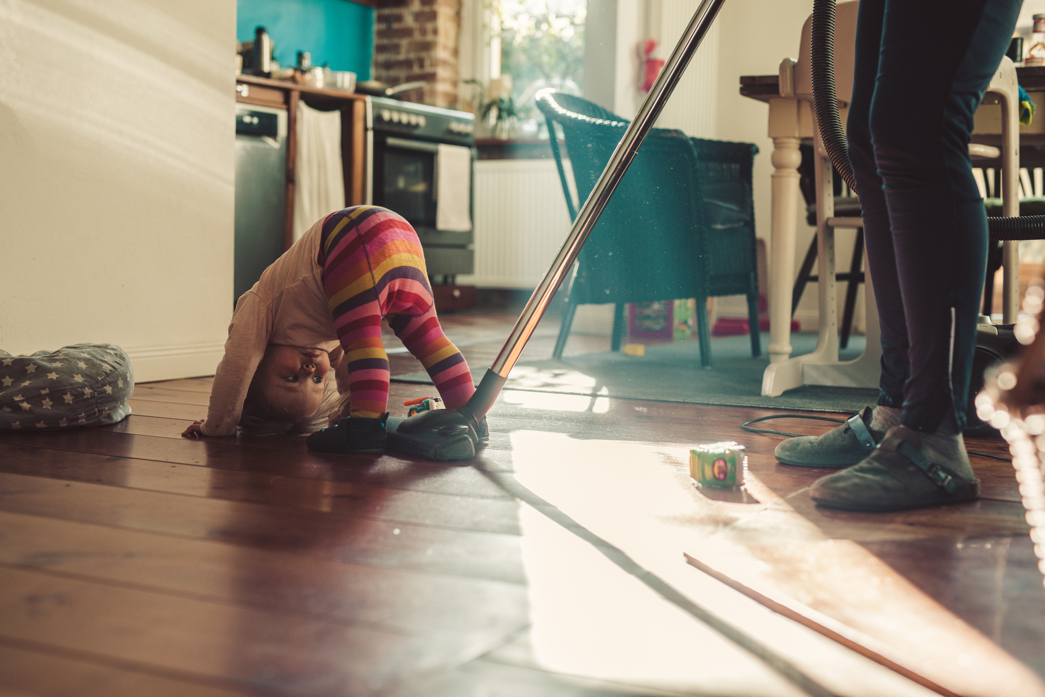 A woman vacuuming with her daughter