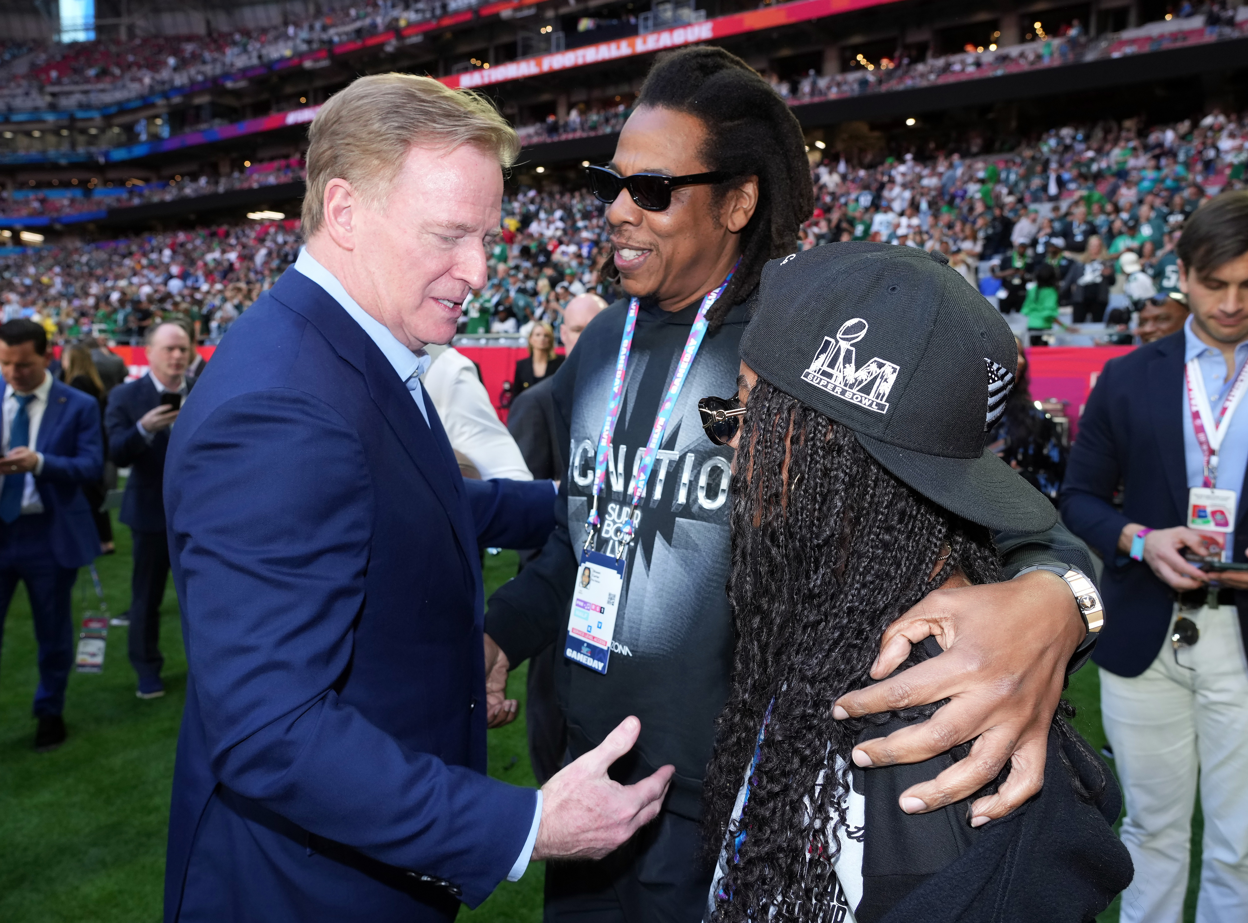 Closeup of Jay-Z talking to NFL Commissioner