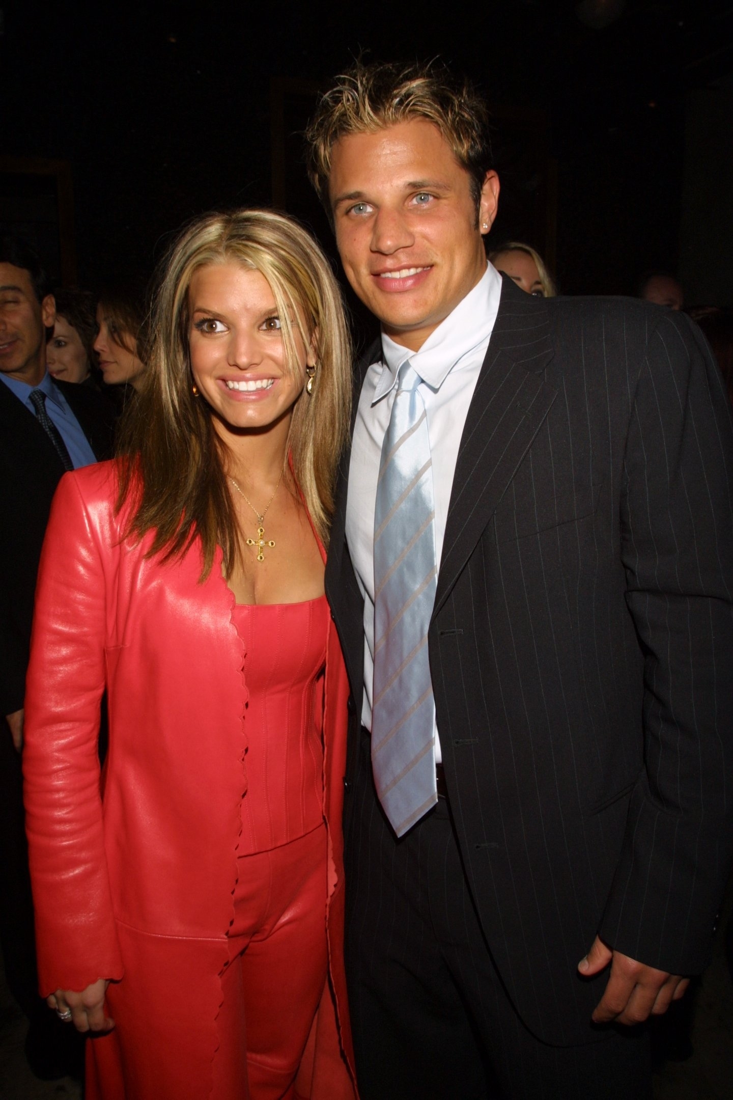 Smiling in a pink pantsuit with Nick Lachey