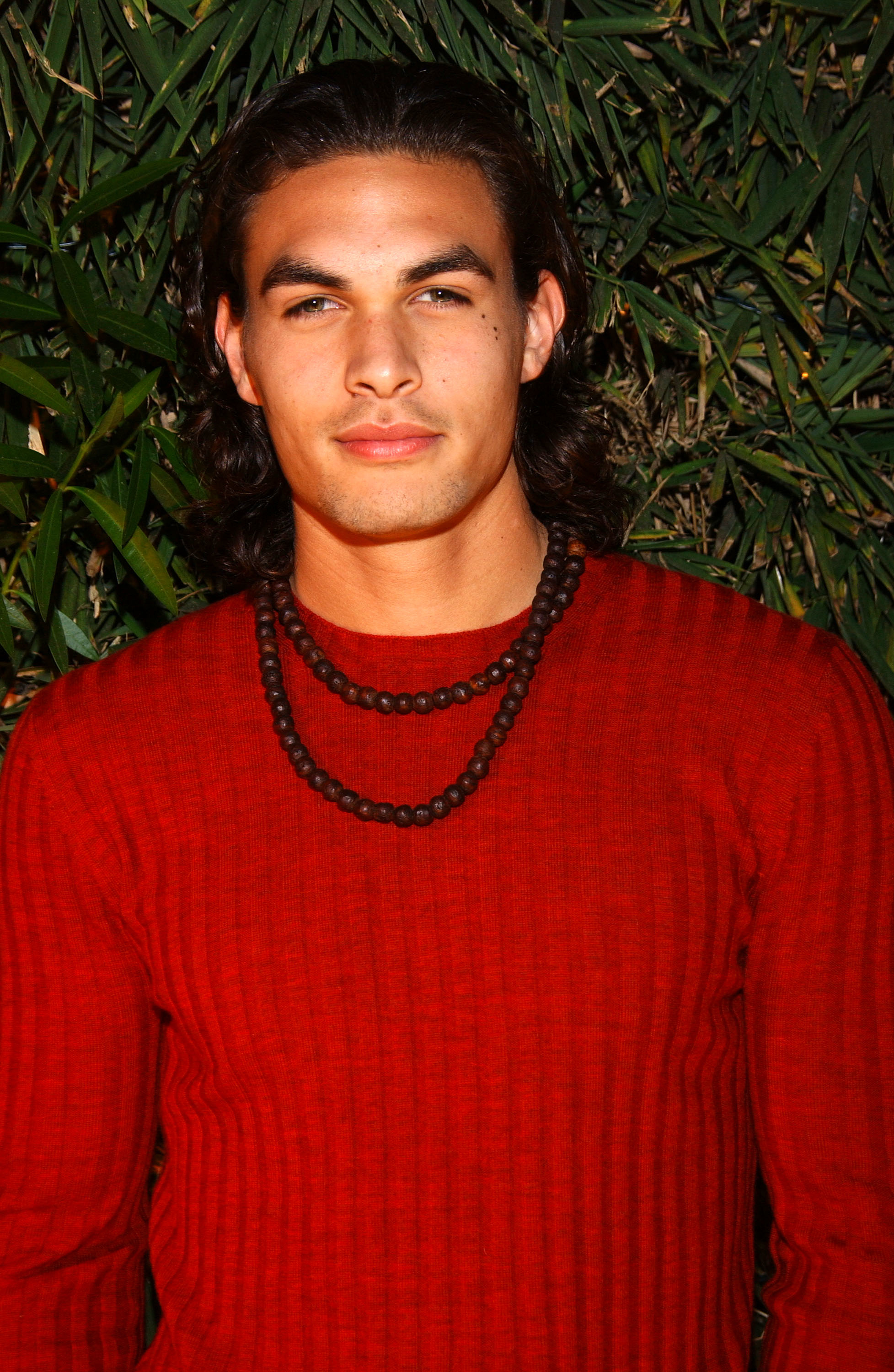 In a red sweater and two-strand necklace