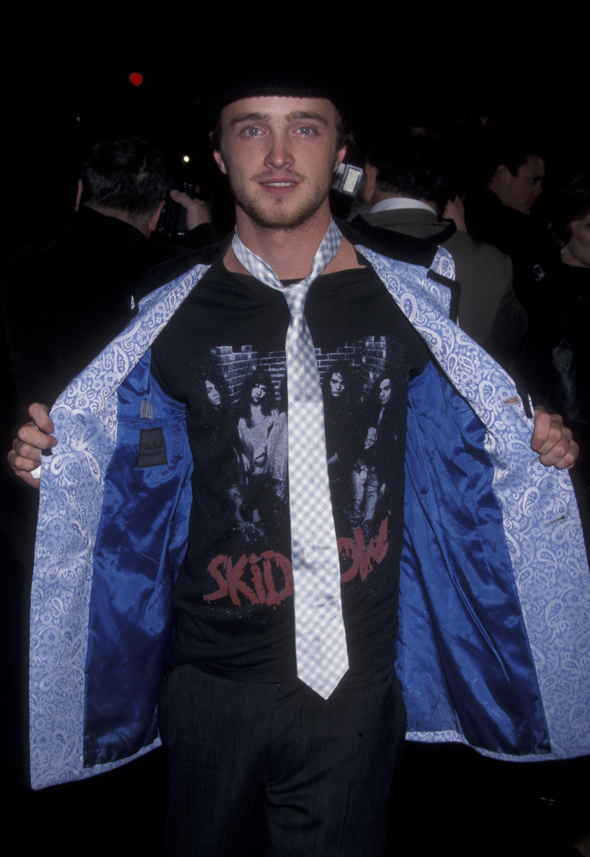 Wearing a Skid Row T-shirt, tie, and open jacket