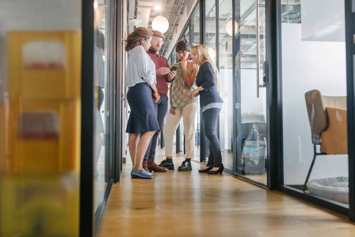 people standing in a hall talking