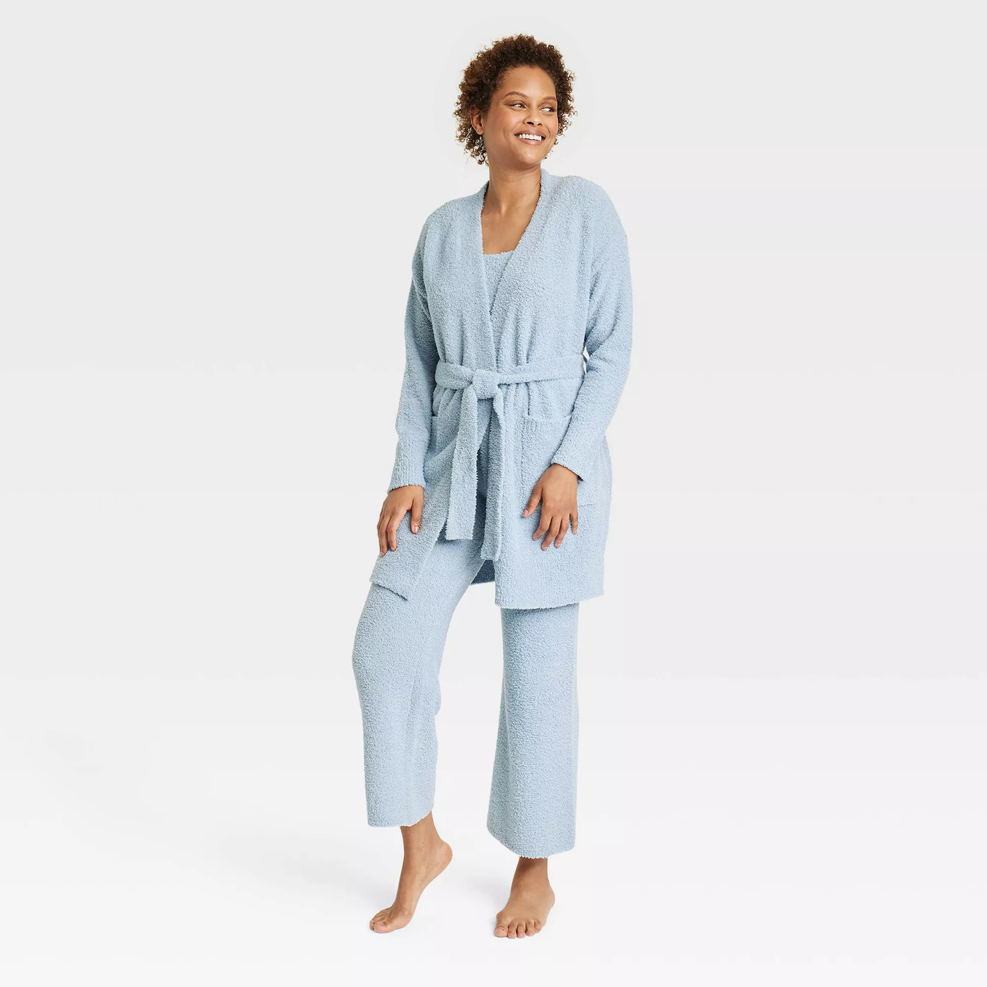A model wearing the fuzzy tie-waist robe in light blue, with the matching tank and pants under it