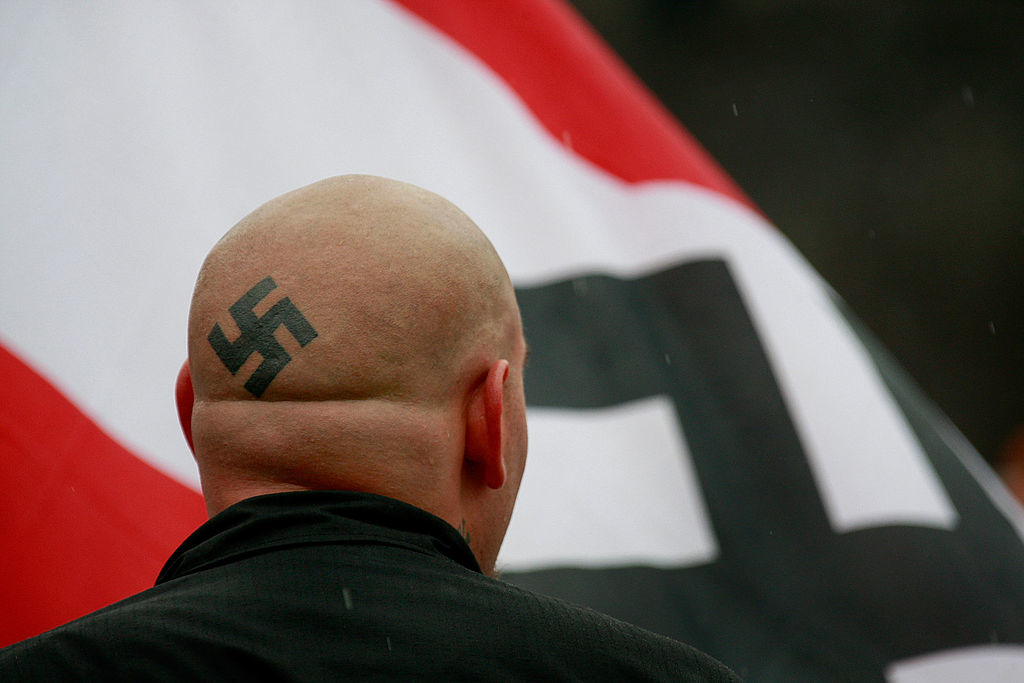 A man with a swastika on his head