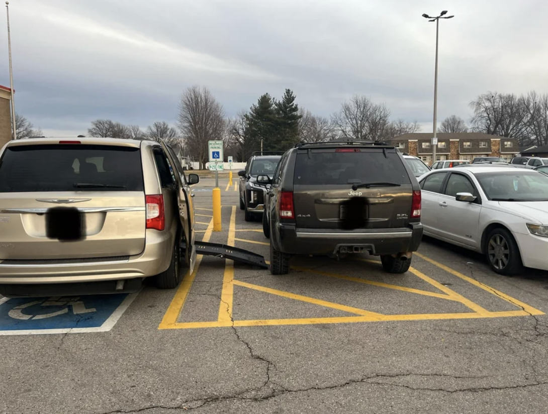 a car parked illegally and blocking the ramp of the car next to them