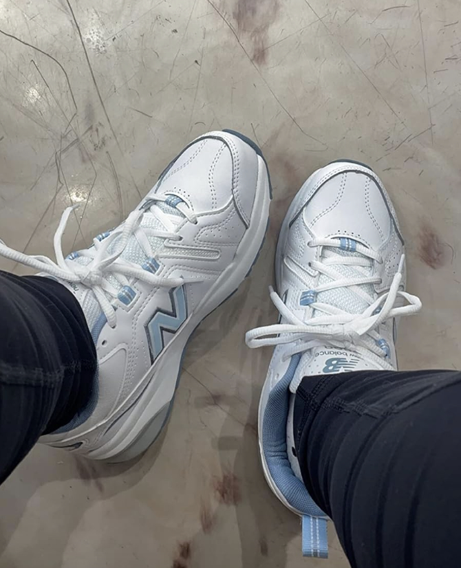 A customer wearing the shoe in white and bluie