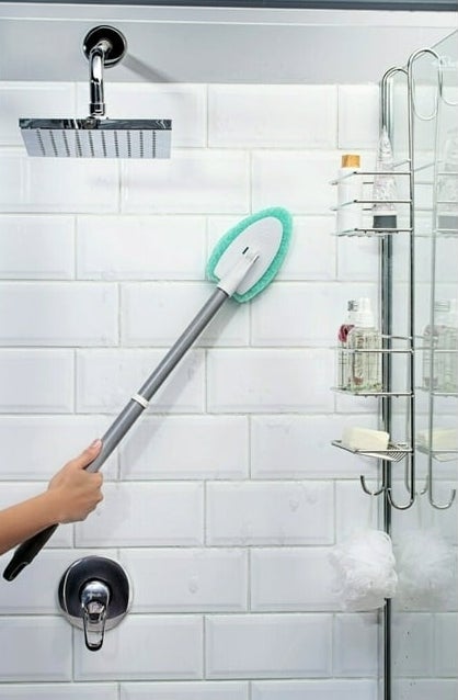 a person using the scrubber inside a shower