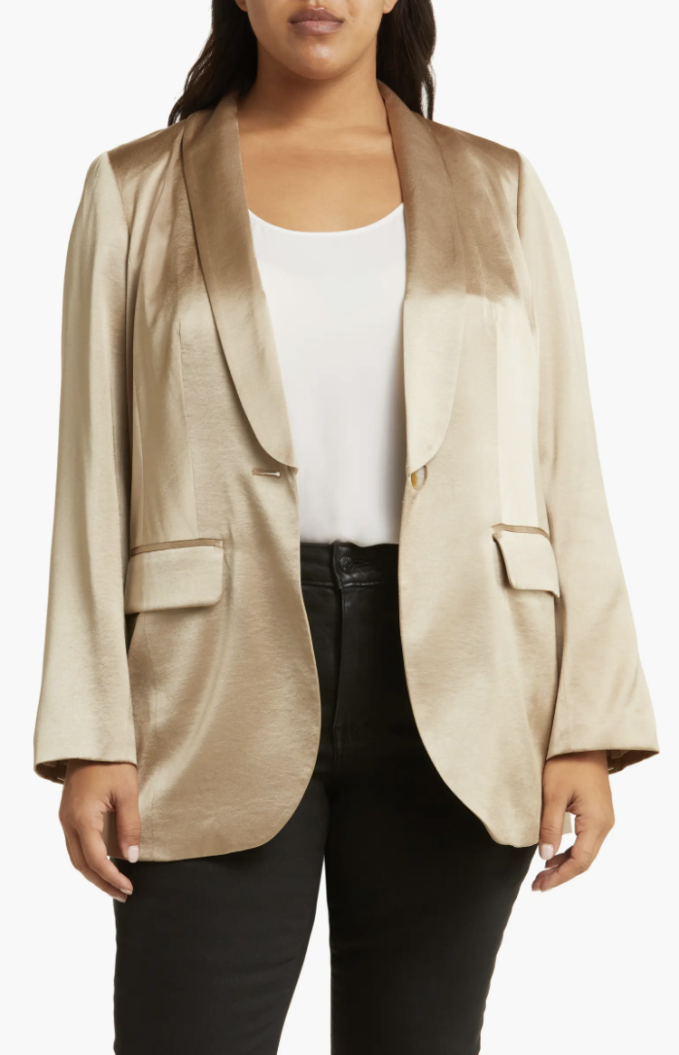 a model wearing the champagne colored satin blazer