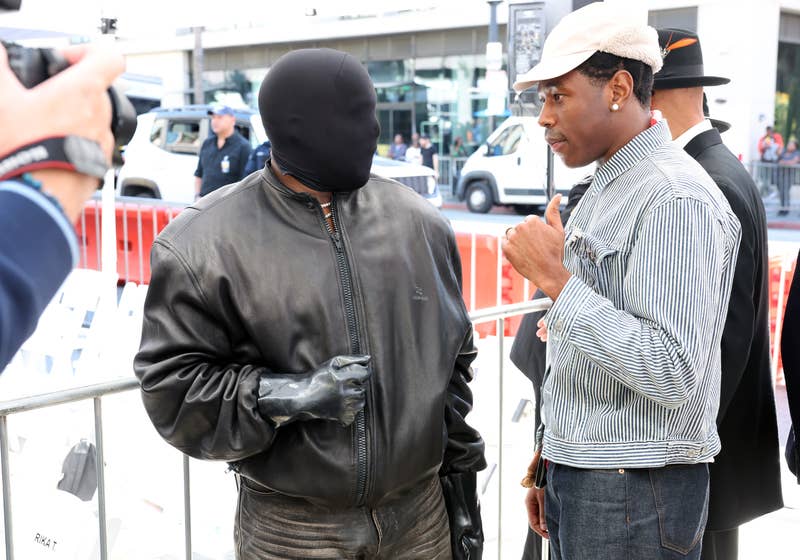 Kanye talking to Tyler the Creator while wearing a face mask