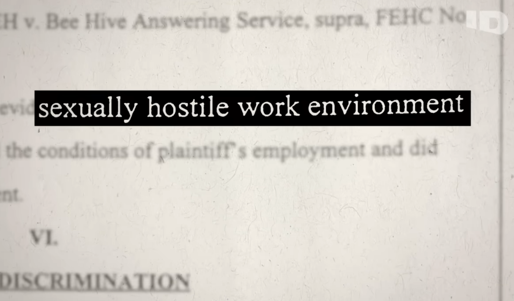 Document close-up highlighting phrase &quot;sexually hostile work environment&quot; in a legal context