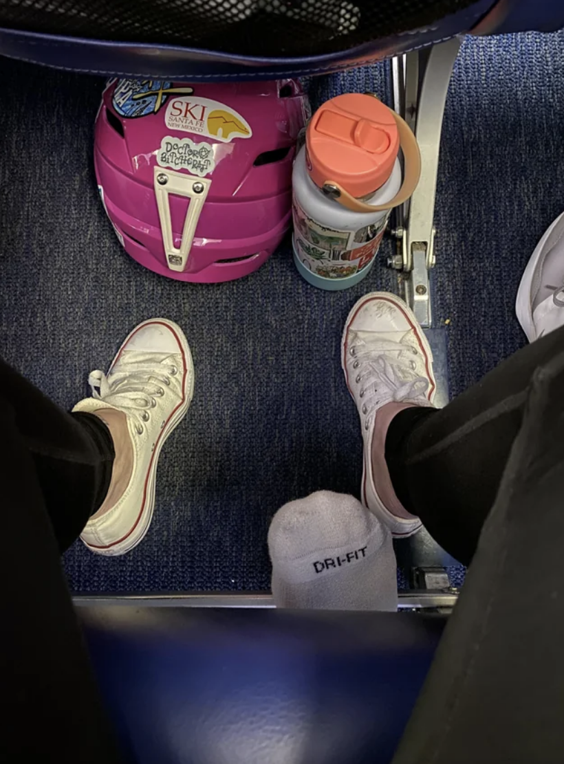 a person's feet poking out from behind