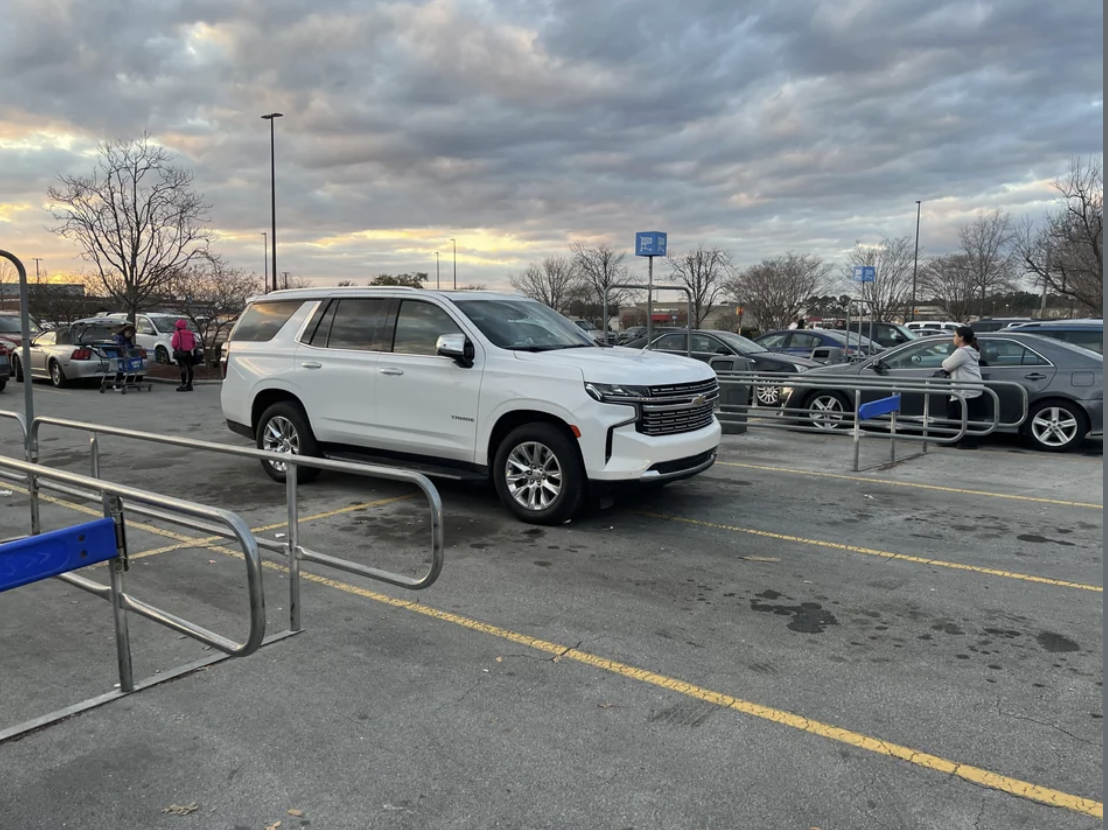 a car taking up four parking spots