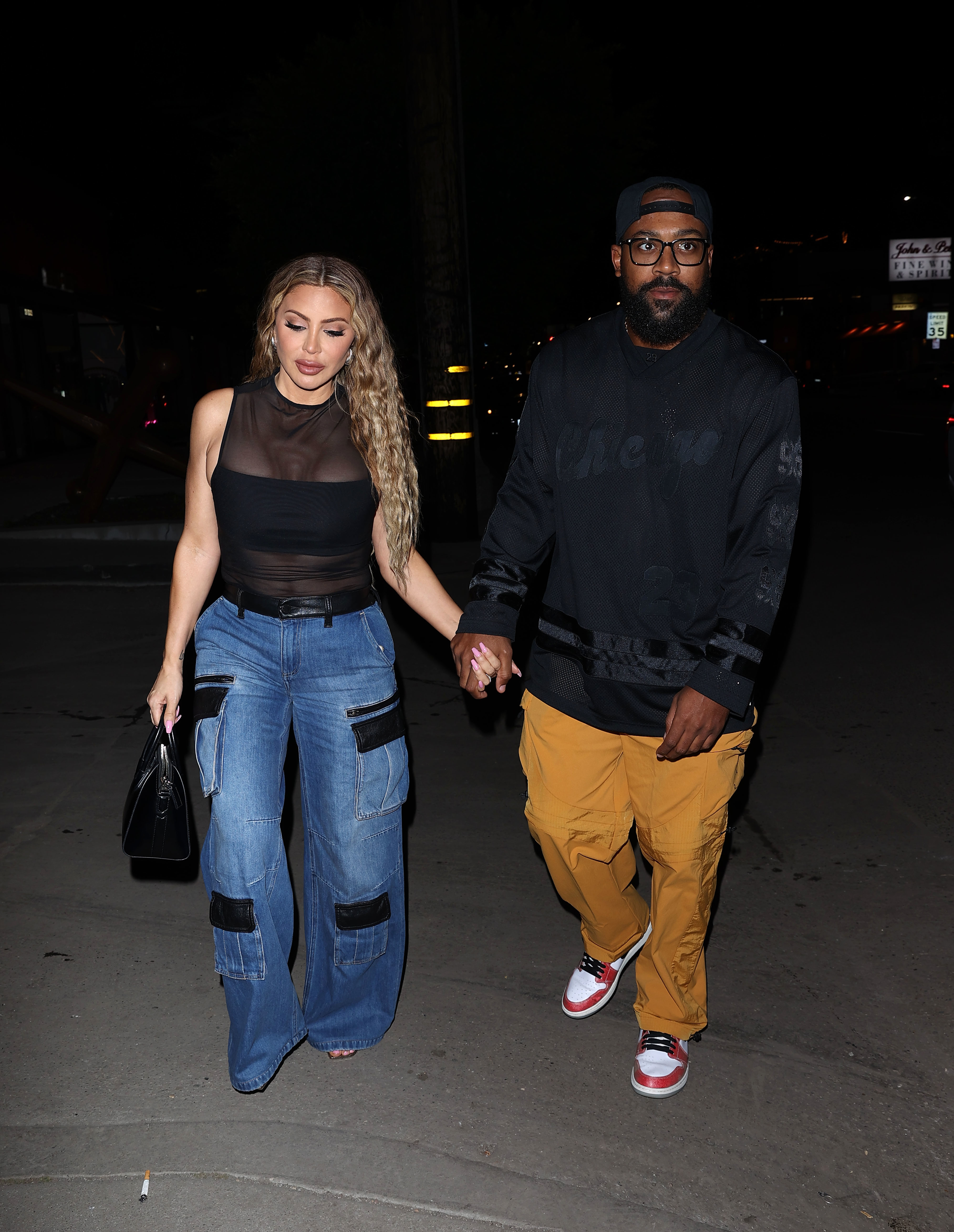 Larsa Pippen and Marcus Jordan walking and holding hands