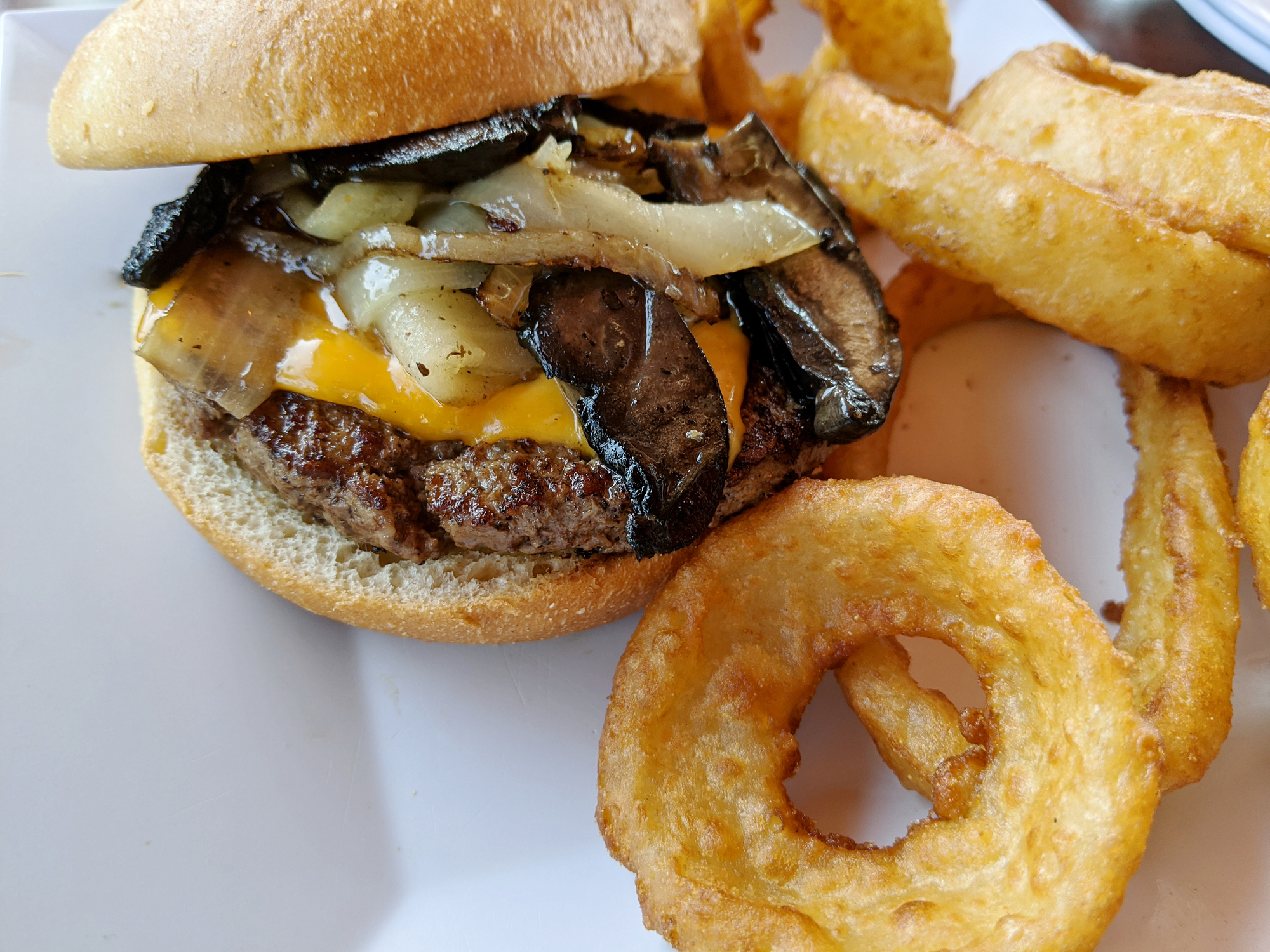 A burger with caramelized onions and mushrooms