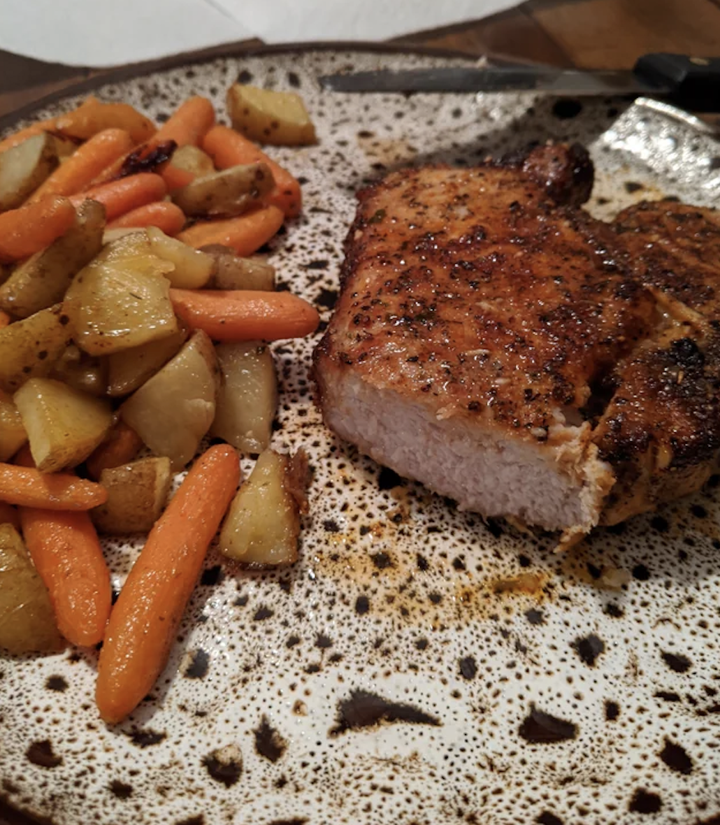 A pork chop with vegetables