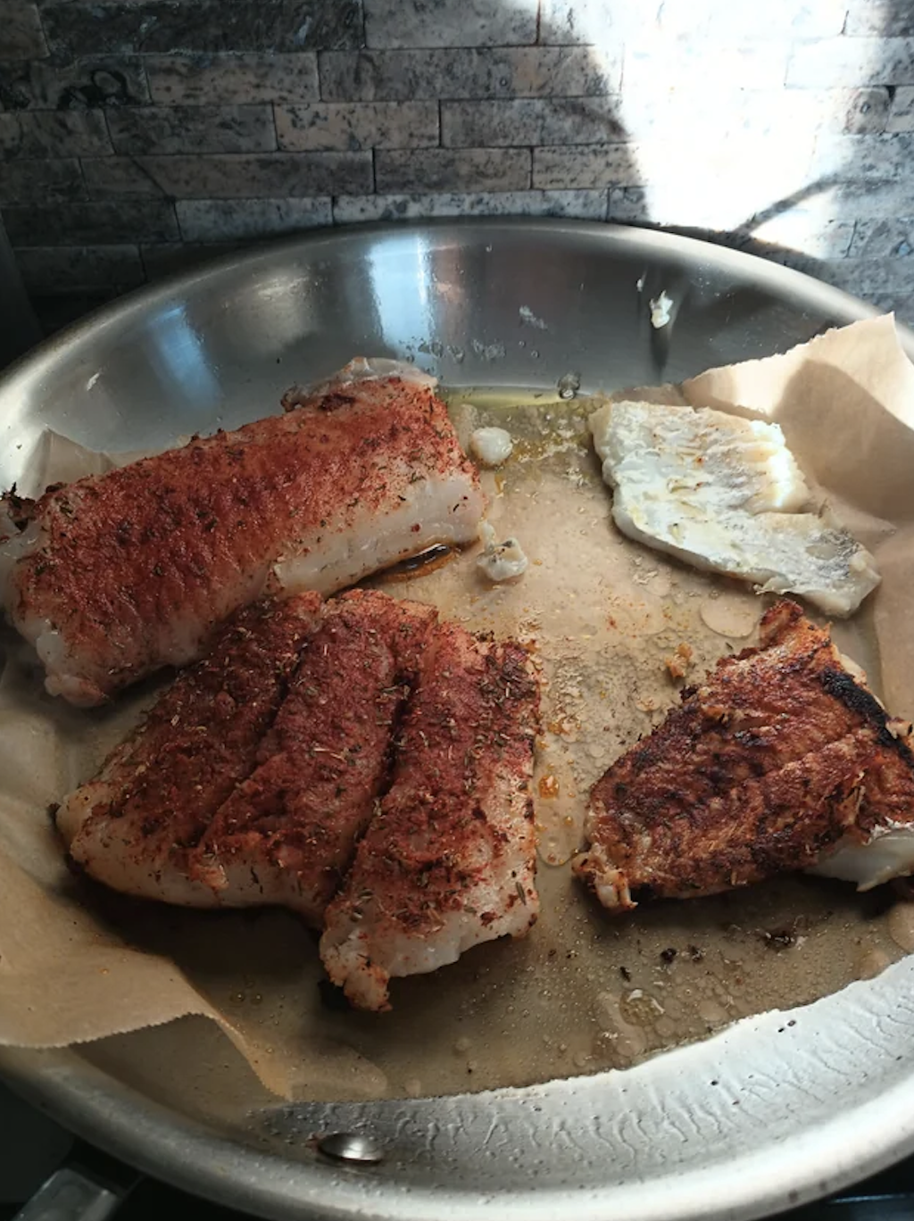 Cooking cod on parchment paper in a frying pan