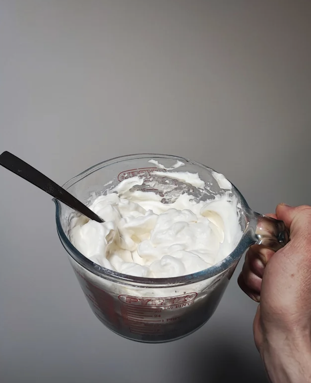 Whipped cream in a measuring cup