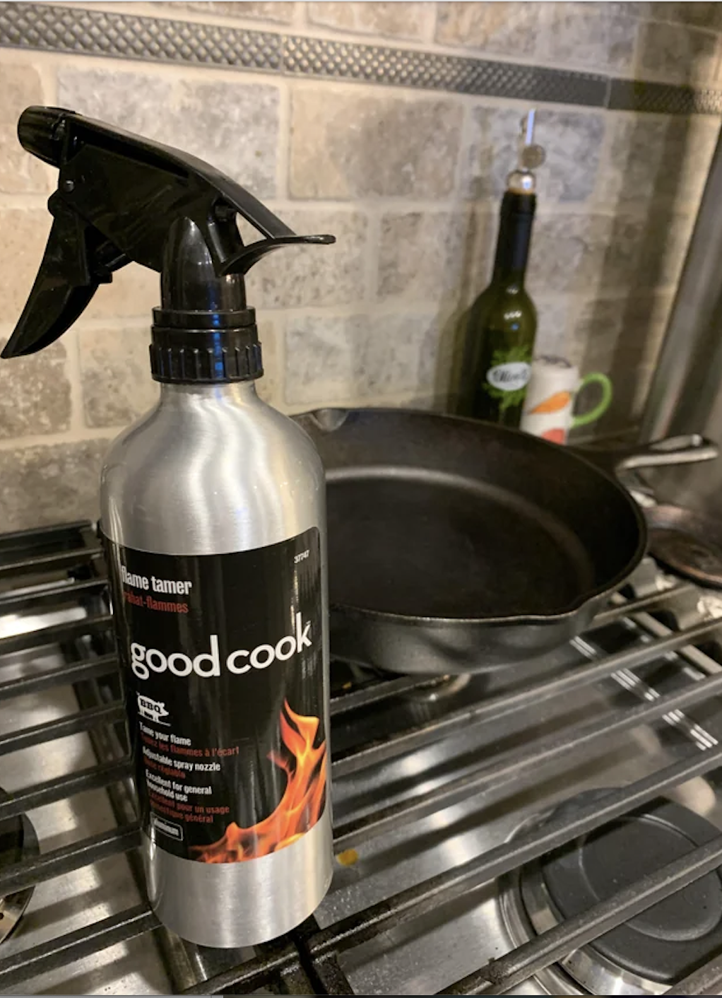 A spray bottle next to a skillet
