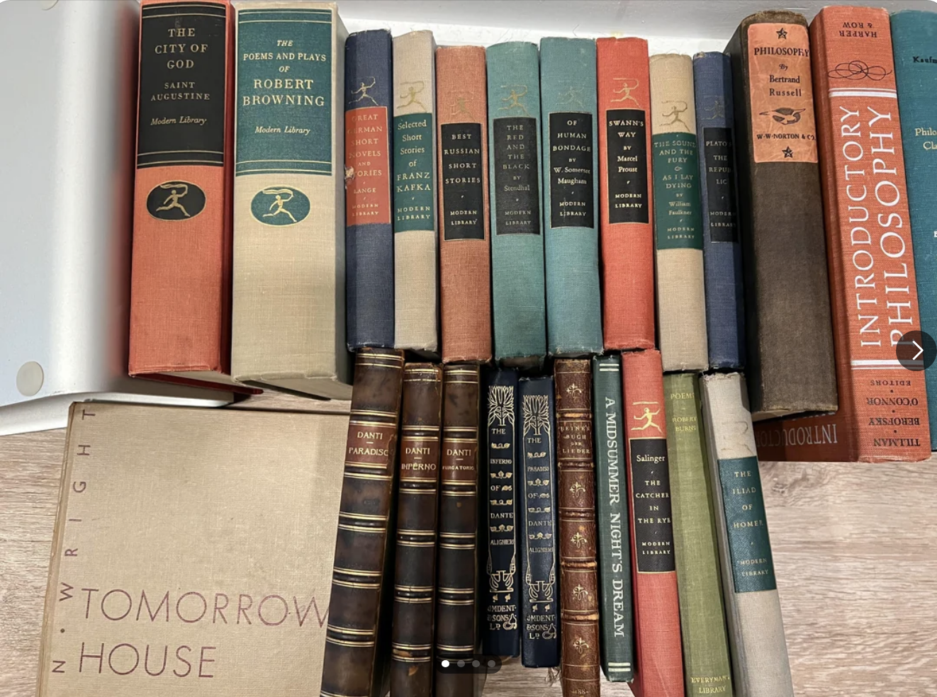 A collection of antique books, their spines facing outward