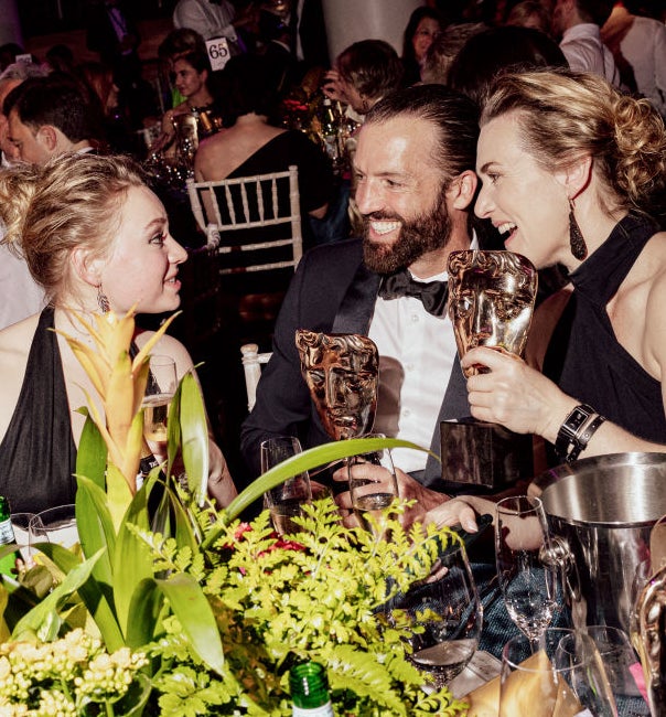 closeup of the two laughing at a table during an event