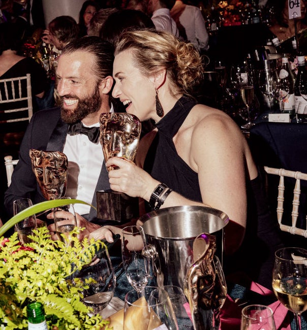 closeup of the two laughing at a table during an event