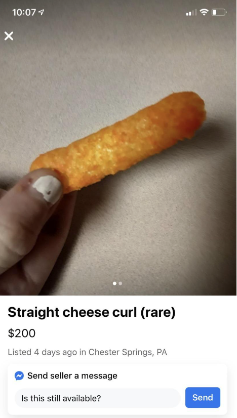 Person holding a rare &quot;straight cheese curl&quot; with a humorous price tag of $200 listed as a rare item for sale