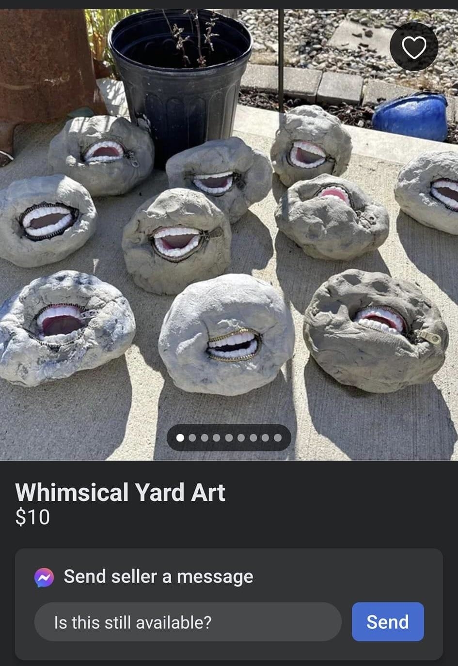 Whimsical rock art resembling mouths with teeth for sale, grouped on concrete, with a plant pot behind