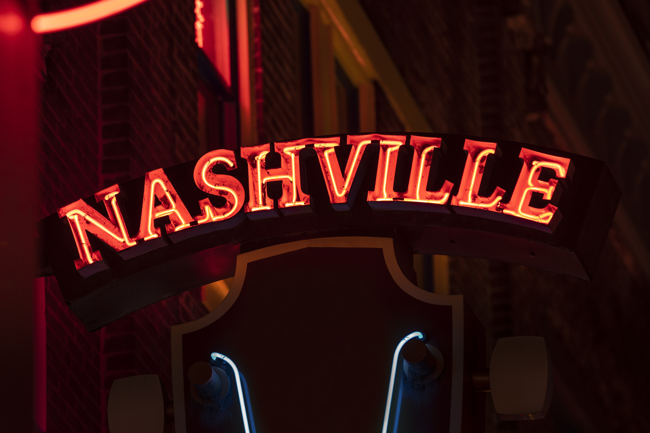 Neon sign reading &#x27;NASHVILLE&#x27; at night, likely indicating the city&#x27;s vibrant scene