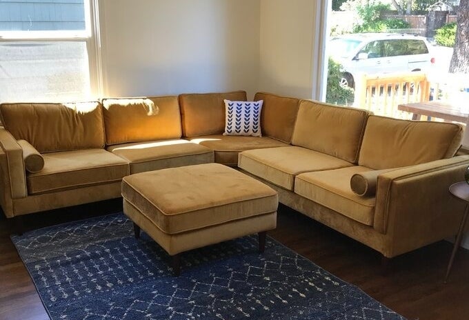 A yellow sectional in a living room