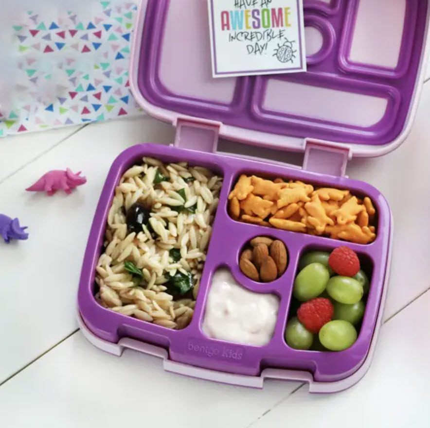 small open lid bentgo plastic lunch box with rice and snacks